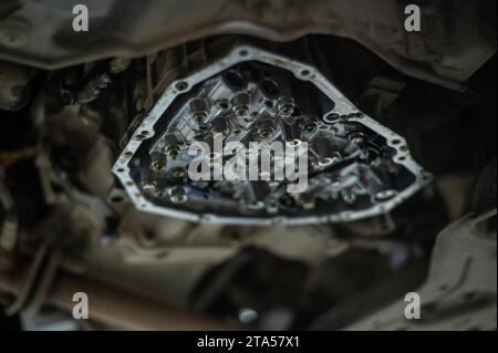 Close-up of a car's CVT gearbox on a lift.  Stock Photo