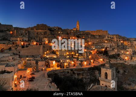 Matera, Italy - 26 November, 2023: view of the old town of Matera after sunset with the lights coming on Stock Photo