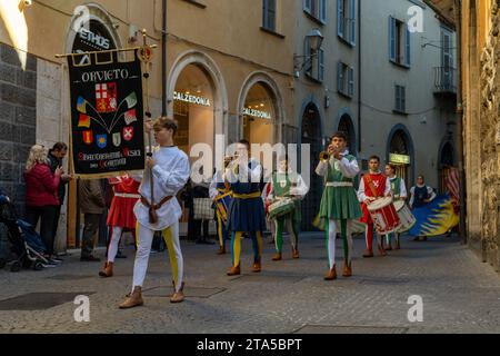 Orvieto, Italy - 18 November, 2023: marching band dressed in medieval clothes marching through the streets of old town Orvieto Stock Photo