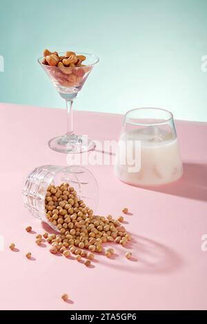 Cocktail glass contained some types nuts displayed with a cup of milk and a lot of soybeans. Soy milk supports a healthy heart from multiple angles Stock Photo