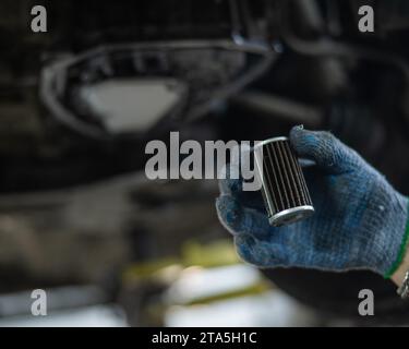 Replacing the old oil filter with a new one Stock Photo - Alamy