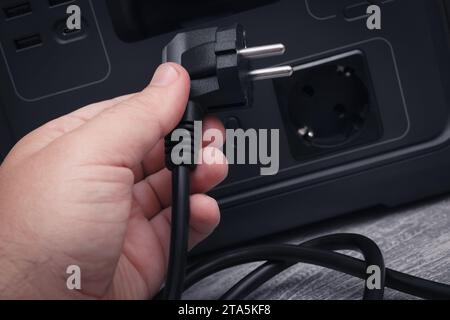 Plug To The Portable Charging Station. Home Or Camping Power Supply And Blackout Maintenance Electricity Accumulator. Selective Focus. Stock Photo
