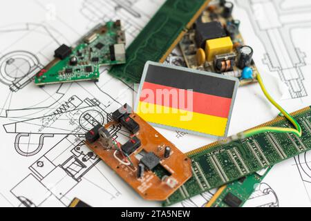 An advanced CPU printed with a national flag of Germany on a neon glowing electronic circuit board. 3D illustration of the concept of German made high Stock Photo