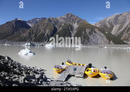Tasman Lake is at the terminal of Tasman Glacier in New Zealand. The lake is one of the few in the world where tourists can cruise up close to ice bur Stock Photo