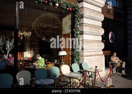Customers sit inside and outside a Caffe Concerto brasserie on Piccadilly in Westminster, on 28th November 2023, in London, England. Stock Photo