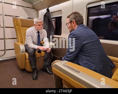 Milan, Italy. 29th Nov, 2023. Czech President Petr Pavel, left, sits on a train on his way from Rome to Milan, Italy November 29, 2023. Petr Pavel ends his three-day visit to Italy, gives speech at Czech-Italian business forum, meets Lombardy's government head, visits Moto Guzzi factory and F-35 assembly plant. Credit: Marek Opatrny/CTK Photo/Alamy Live News Stock Photo