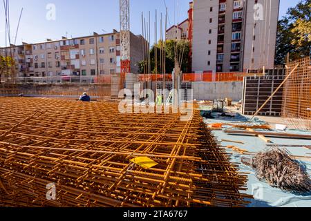 Pile of rusty rectangle steel reinforcement for concrete ready for installation placed at construction site. Stock Photo