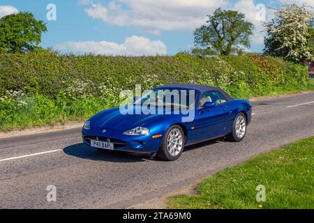 1996 90s nineties Blue British Jaguar XK8 Convertible Auto; Vintage, restored classic motors, automobile collectors motoring enthusiasts, historic veteran cars travelling in Cheshire, UK Stock Photo