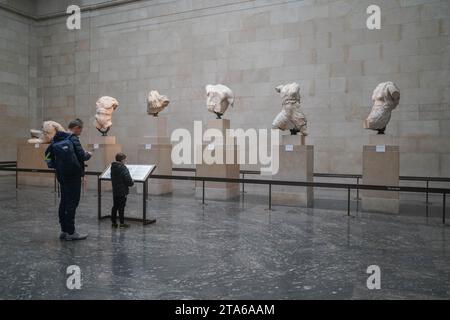 London UK. 29 November 2023.  Visitors at the British Museum view the Elgin Marbles also known as Parthenon Sculptures  which is  at the centre of a diplomatic row between the UK and Greece. Prime Minister Rishi Sunak has cancelled a scheduled meeting with the Greek Prime Minister Kyriakos Mitsotakis  who had been expected to meet the his British counterpart  today during his visit to London . There is a  longstanding disagreement between Greece  about whether the marbles should be returned to Athens Credit: amer ghazzal/Alamy Live News . Stock Photo