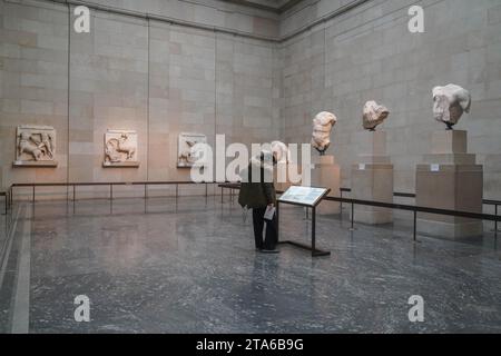 London UK. 29 November 2023.  Visitors at the British Museum view the Elgin Marbles also known as Parthenon Sculptures  which is  at the centre of a diplomatic row between the UK and Greece. Prime Minister Rishi Sunak has cancelled a scheduled meeting with the Greek Prime Minister Kyriakos Mitsotakis  who had been expected to meet the his British counterpart  today during his visit to London . There is a  longstanding disagreement between Greece  about whether the marbles should be returned to Athens Credit: amer ghazzal/Alamy Live News . Stock Photo