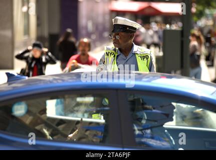 NEW YORK, USA - May 30, 2018: NYPD police officer performing his duties on the streets of Manhattan. Stock Photo