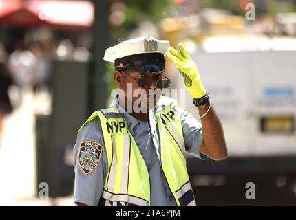 NEW YORK, USA - May 30, 2018: NYPD police officer performing his duties on the streets of Manhattan. Stock Photo