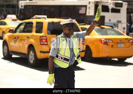 NEW YORK, USA - May 30, 2018: NYPD police officer performing his duties on the streets of Manhattan. Stock Photo