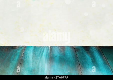 Rustic painted green table with beautiful gold Christmas bokeh. Free space for text. Stock Photo