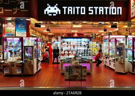 TOKYO, JAPAN - DECEMBER 1, 2016: People claw grabber machine arcade in night Akihabara district of Tokyo. Akihabara district has reputation for electr Stock Photo