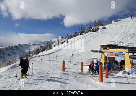 BAD HOFGASTEIN, AUSTRIA - MARCH 9, 2016: People ride a ski lift in Bad Hofgastein. It is part of Ski Amade, one of largest ski regions in Europe with Stock Photo