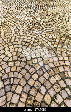Tufa / limestone setts laid in circular fan pattern in city courtyard garden - Tours, Indre-et-Loire (37), France. Stock Photo