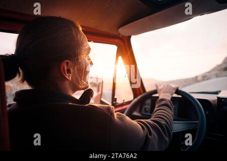 Young man driving man at sunset on vacation Stock Photo