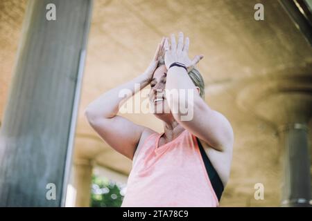 Low angle view of exhausted mature woman during workout Stock Photo