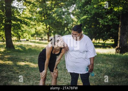Happy multiracial female friends laughing together at park Stock Photo