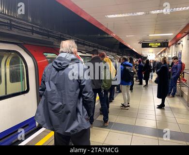London, UK. 28th November, 2023. Commuters and passengers wait for a London Underground tube at Waterloo Railway Station in London to Bank Underground Station. The Waterloo & City train had to return to the depot causing passenger delays. Credit: Maureen McLean/Alamy Stock Photo