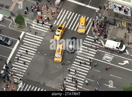 New York, USA - June 8, 2018: Top view at the cars go through the intersection. View from skyscrapers on the streets of New York City. Stock Photo