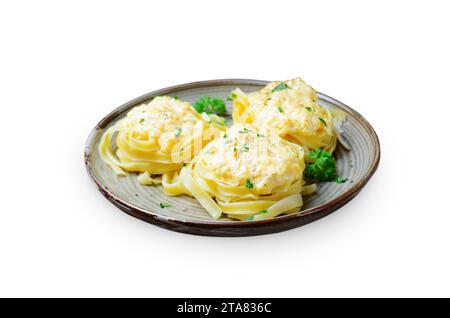 Pasta Nests with Creamy Sauce on a Plate, Freshly Cooked Pasta on White Background Stock Photo