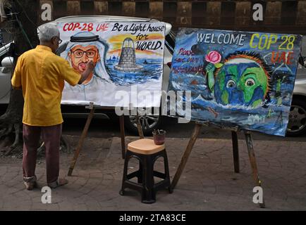 Mumbai, Maharashtra, India. 29th Nov, 2023. A teacher from Gurukul school of art seen painting amid the welcoming of the Conference of the Parties of the UNFCCC (COP 28) in Mumbai. Conference of the Parties of the UNFCCC (COP 28) will be held from 30th November to 12 December 2023 at Expo City Dubai in United Arab Emirates (UAE) to tackle the global challenge of climate change. (Credit Image: © Ashish Vaishnav/SOPA Images via ZUMA Press Wire) EDITORIAL USAGE ONLY! Not for Commercial USAGE! Stock Photo