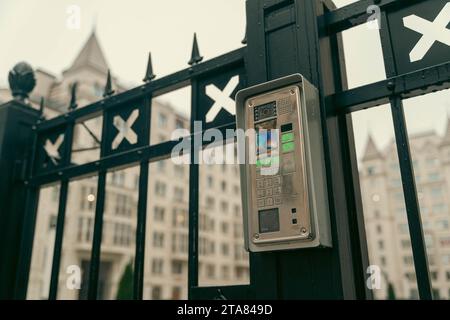 A modern video intercom system installed at the gates of a contemporary housing development, providing security and access control for residents and v Stock Photo