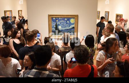 New York, USA - May 25, 2018: Crowd of people near the Starry Night by Vincent van Gogh painting in Museum of Modern Art in New York City. Stock Photo