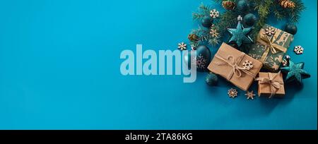 Christmas background. Gift boxes tied ribbons and christmas decorations on turquoise background. Stock Photo