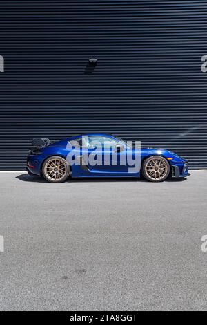 A beautiful brand new Gentian Blue Porsche Cayman GT4 RS waiting to be collected by the new owner and driven to the mountains. Stock Photo