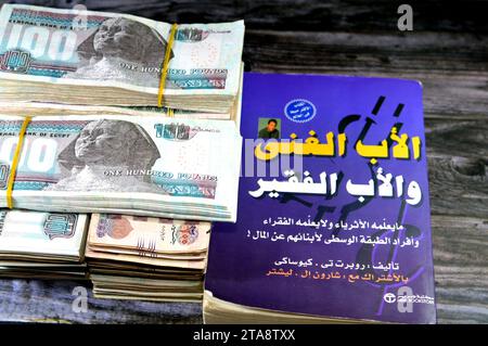 Cairo, Egypt, November 21 2023: Stacks of Egypt money banknote bills EGP LE thousands of Pounds currency banknotes bill, and The Arabic version of Ric Stock Photo