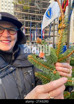 Beautiful senior woman displaying her clipping from the Rockefeller Center Christmas tree, 2023, New York City, United States Stock Photo