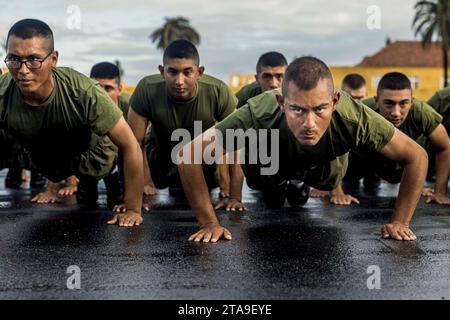 November 16, 2023 - Marine Corps Recruit Depot San D, California, USA - New U.S. Marines with Alpha Company, 1st Recruit Training Battalion, execute Marine Corps push-ups during a motivational run at Marine Corps Recruit Depot San Diego, Nov. 16, 2023. The motivational run is the final training event the Marines complete before graduating and consists of a three-mile run throughout the Depot. (Credit Image: © Jacob Hutchinson/U.S. Marine/ZUMA Press Wire) EDITORIAL USAGE ONLY! Not for Commercial USAGE! Stock Photo