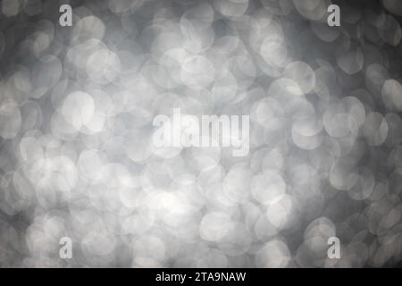 Sparkling blurred silver sequins. Festive background. Christmas texture. New Year background. Stock Photo