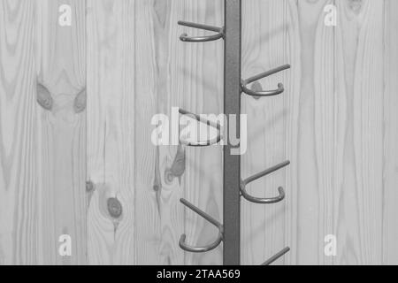Metal structure clothes hanger hooks on wooden grey background close-up. Stock Photo