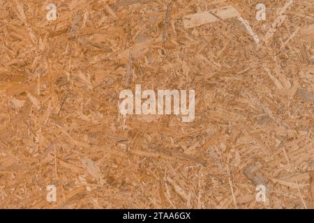 Chipboard brown osb surface pressed wood pattern texture particleboard background construction material press board. Stock Photo