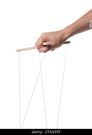 Man holding puppet control bar with strings on white background, closeup Stock Photo