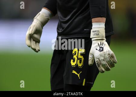 Milan, Italy. 28th Nov, 2023. The Pope's branded Goalkeeper gloves of Marcel Lotka of Borussia Dortmund during the warm up prior to the UEFA Champions League match at Giuseppe Meazza, Milan. Picture credit should read: Jonathan Moscrop/Sportimage Credit: Sportimage Ltd/Alamy Live News Stock Photo