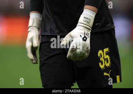 Milan, Italy. 28th Nov, 2023. The Pope's branded Goalkeeper gloves of Marcel Lotka of Borussia Dortmund during the warm up prior to the UEFA Champions League match at Giuseppe Meazza, Milan. Picture credit should read: Jonathan Moscrop/Sportimage Credit: Sportimage Ltd/Alamy Live News Stock Photo