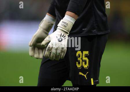 Milan, Italy. 28th Nov, 2023. The Pope's branded Goalkeeper gloves of Marcel Lotka of Borussia Dortmund during the warm up prior to the UEFA Champions League match at Giuseppe Meazza, Milan. Picture credit should read: Jonathan Moscrop/Sportimage Credit: Sportimage Ltd/Alamy Live News Stock Photo