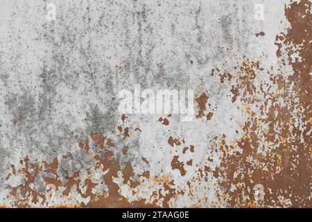 Old white peeling paint with rusty brown metal surface texture background. Stock Photo