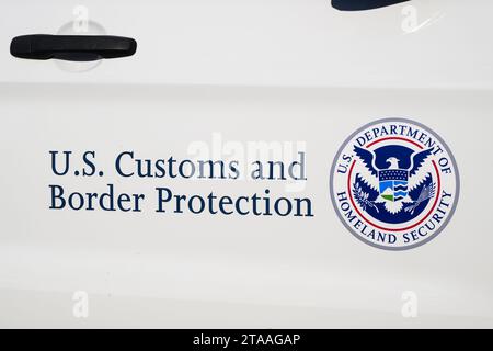 Anacortes, WA, USA - November 28, 2023; Sign on car door for U.S. Customs and Border Protection and badge for U.S. Department of Homeland Security Stock Photo