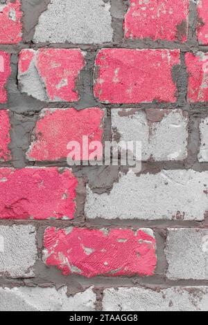 Old brickwork white silicate blocks brick cement color pink paint texture background wall vertical. Stock Photo