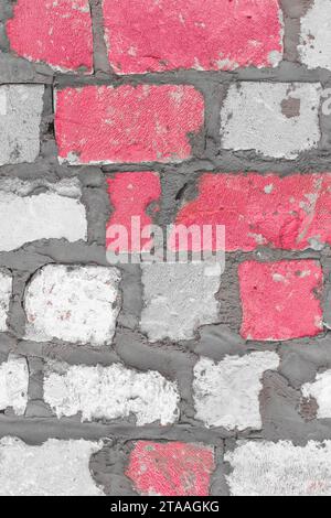 Old brickwork white silicate blocks brick color pink paint texture background wall vertical. Stock Photo