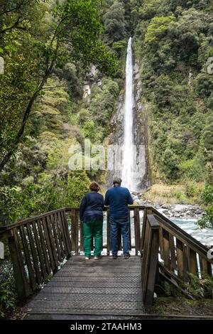 Road trip around the South Island of New Zealand. pictured at  An extremely tall and easy accessible 96-metre waterfall, Thunder Creek Falls is locate Stock Photo