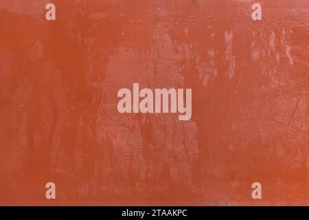 Wet water surface of orange brown leather streaks background texture. Stock Photo