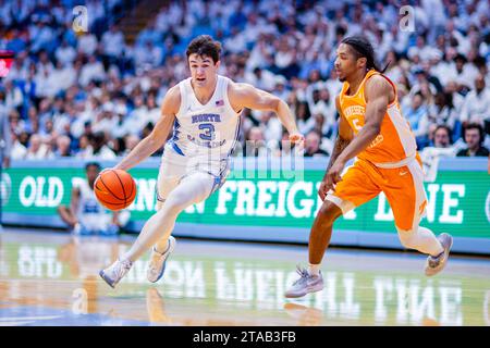 Chapel Hill, NC, USA. 29th Nov, 2023. North Carolina Tar Heels guard Cormac Ryan (3) drives to the basket against Tennessee Volunteers guard Zakai Zeigler (5) during the first half of the NCAA basketball matchup at Dean Smith Center in Chapel Hill, NC. (Scott Kinser/CSM). Credit: csm/Alamy Live News Stock Photo