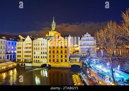 Evening view on Vltava River, historic townhouses and spire of the Old town Water Tower from the Charles Bridge, Prague, Czechia Stock Photo